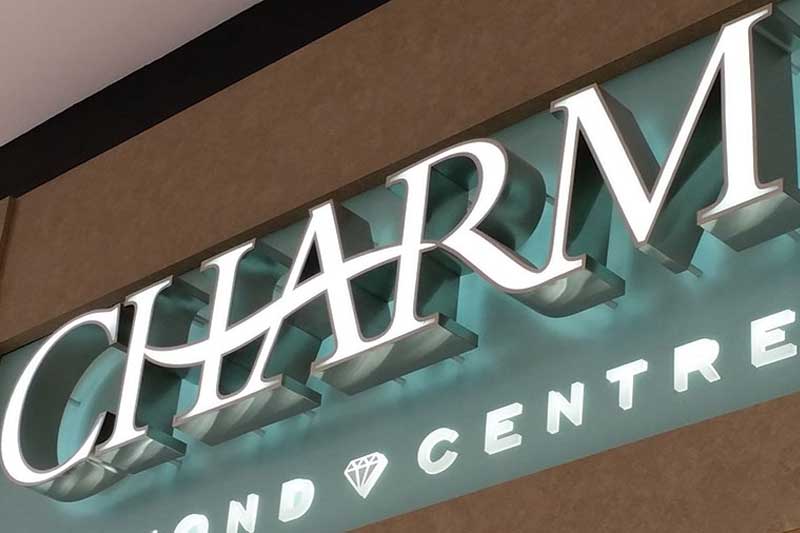 An elegant sign in face and back lighted stainless steel at charm jewelers